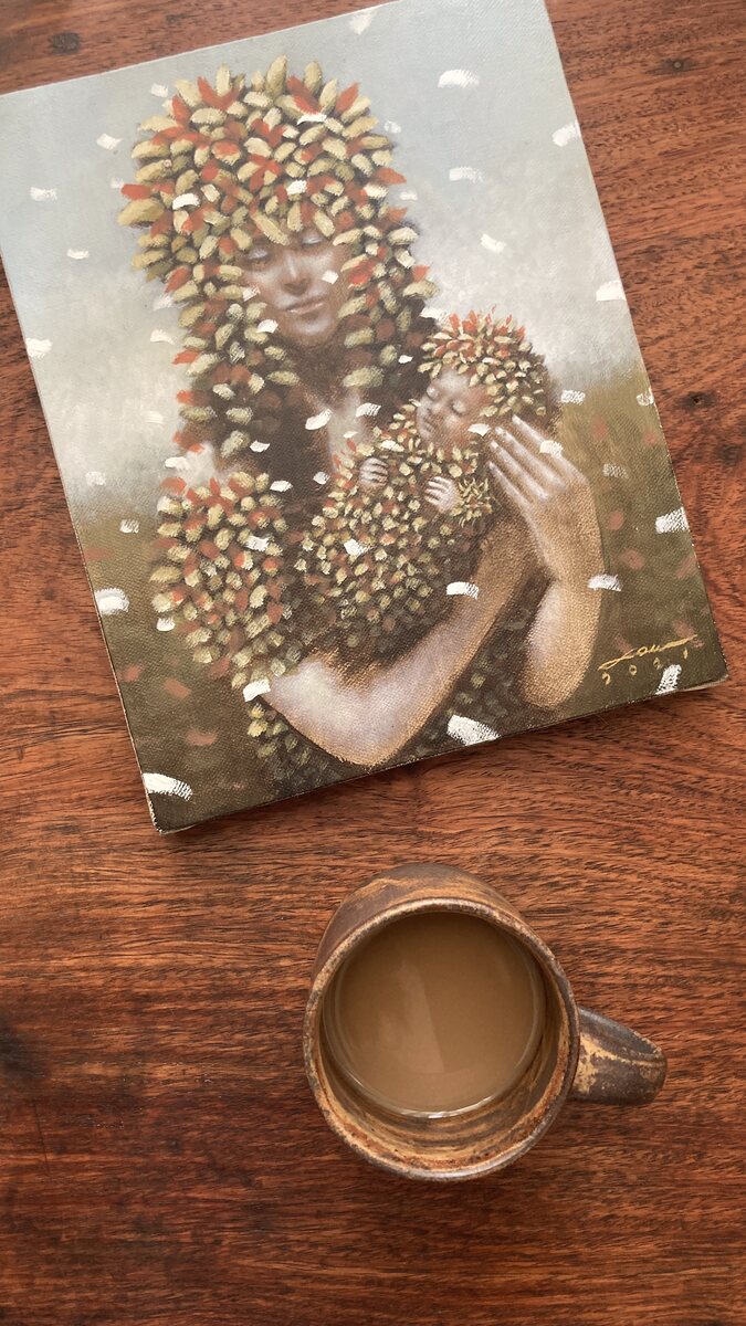 A mug on a wooden table, the light coming in low. Handmade Philippine stoneware by AWIS in everyday use.