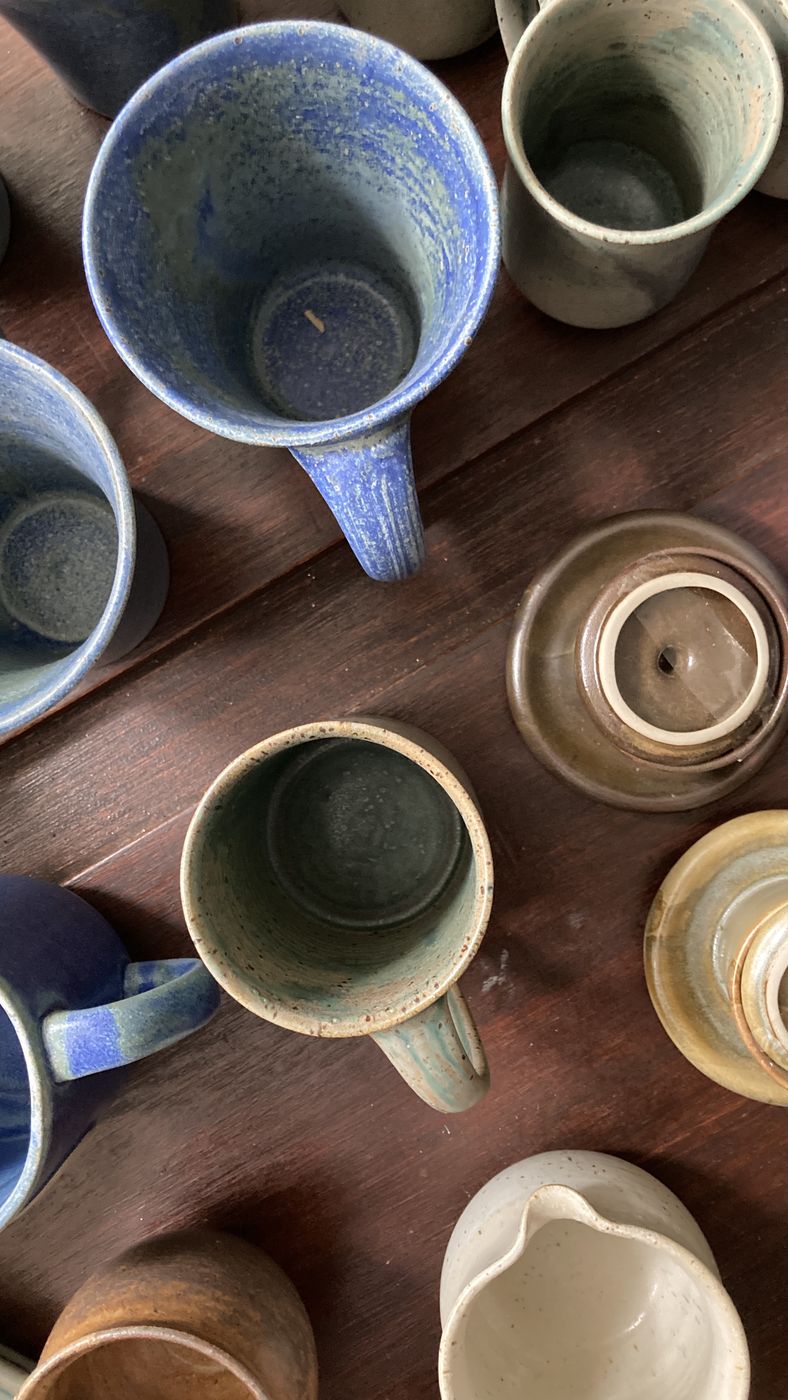 Handmade Philippine stoneware mugs and creamer grouped together, AWIS