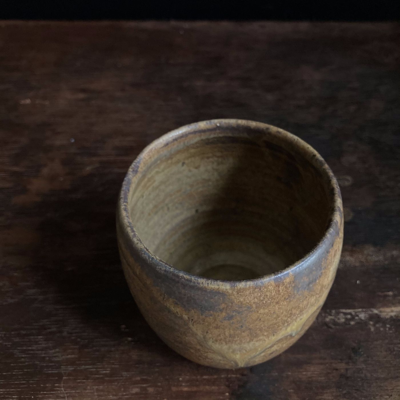 Handmade brown stoneware handleless cup by a Philippine potter, AWIS